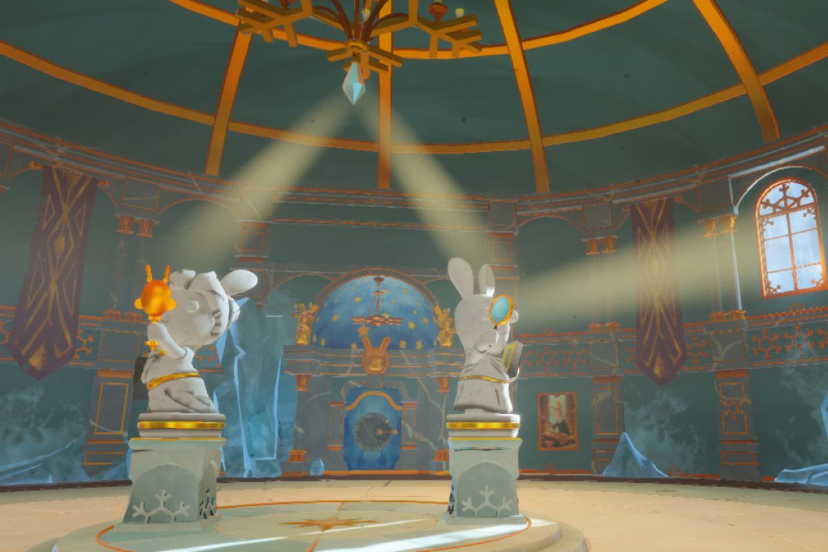 Sunlight bounces off of two rabbids statues in the Winter Palace of Mario + Rabbids Sparks of Hope’s Pristine Peaks region.