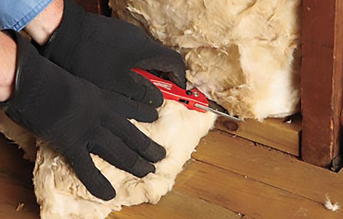 Man Trimming Length Of Insulation
