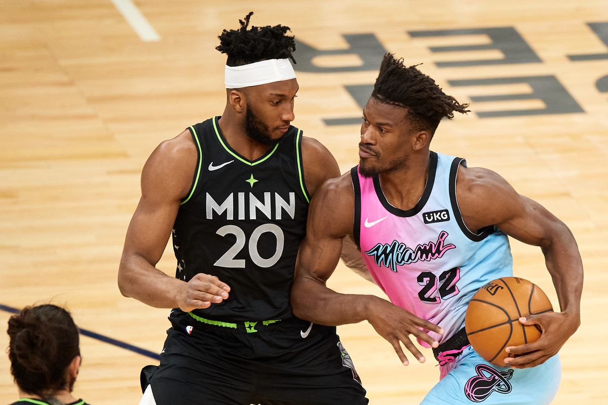 Josh Okogie of the Minnesota Timberwolves defends against Jimmy Butler of the Miami Heat during the third quarter of the game at Target Center on April 16, 2021 in Minneapolis, Minnesota. The Timberwolves defeated the Heat 119-112.&nbsp;