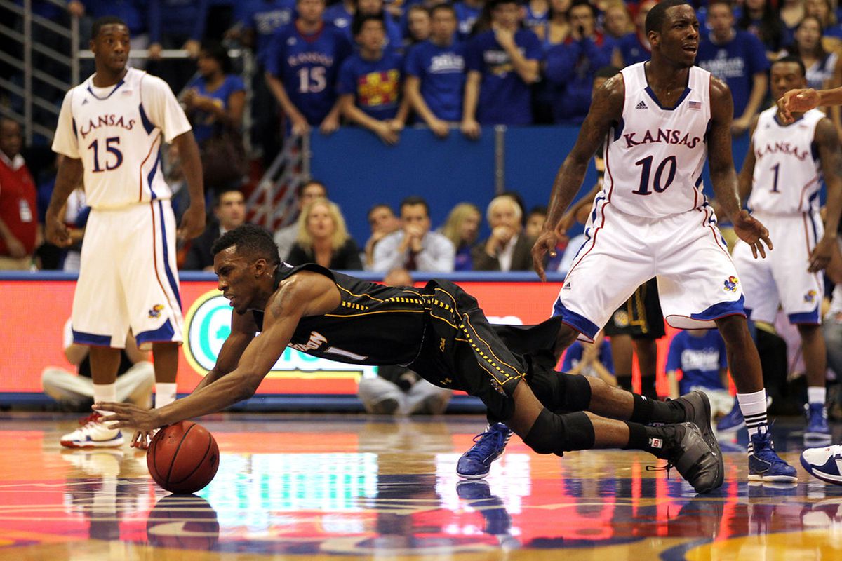 LAWRENCE, KS - NOVEMBER 11:  Marcus Damas #1 of the Towson Tigers dives for a loose ball during the game against the Kansas Jayhawks on November 11, 2011 at Allen Fieldhouse in Lawrence, Kansas.  (Photo by Jamie Squire/Getty Images)