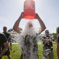 Officer Wes Land dumps a bucket on himself during the the Utah Law Enforcement Memorial Ice Water Challenge at Draper Historic Park, Wednesday, Sept. 3, 2014. One bucket of ice water was dumped on an officer's head for each of the 137 officers who have been killed in the line of duty in Utah.