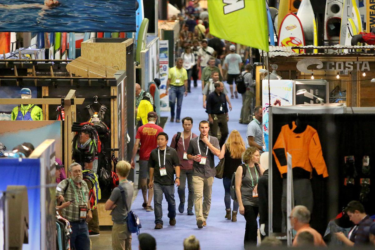 People walk through the Outdoor Retailer show at the Salt Palace Convention Center in Salt Lake City on Friday, July 28, 2017.