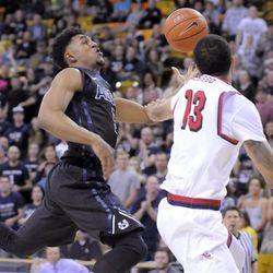 Utah State guard Julion Pearre (5) gets fouled by Fresno State forward Cullen Russo (13) while driving to the basket , Saturday, March 5, 2016, in Logan, Utah. 