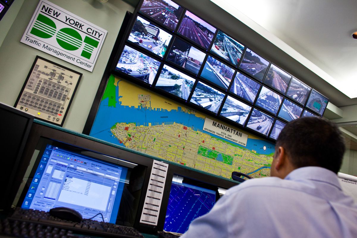 A man sits at the Traffic Management Center for New York, located in Queens, among many monitors.
