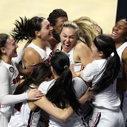 Gonzaga Bulldogs guard Jill Townsend (32) is swarmed by teammates after hitting the game-winning shot with .6 seconds on the clock to defeat BYU 43-42 in the WCC women’s basketball tournament finals at the Orleans Arena in Las Vegas on Tuesday, March 9, 2021. Gonzaga won 43-42.