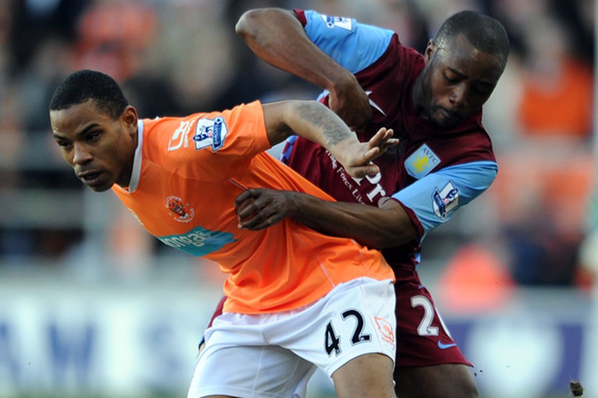 Aston Villa's Nigel Reo-Coker tries desperately to save Blackpool's Jason Puncheon from a spot of lava.