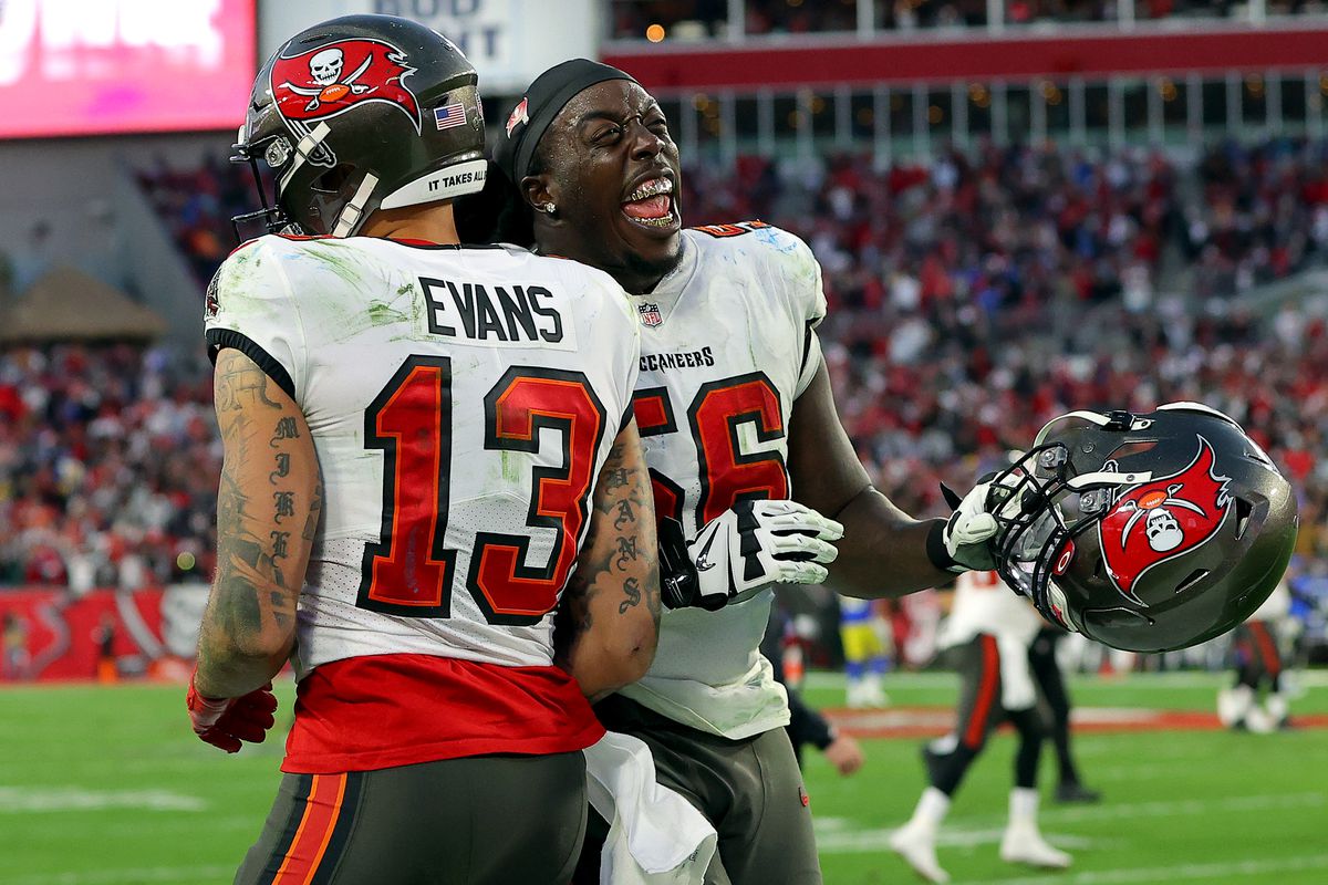 Mike Evans #13 and Rakeem Nunez-Roches #56 of the Tampa Bay Buccaneers celebrate after a touchdown during the fourth quarter against the Los Angeles Rams in the NFC Divisional Playoff game at Raymond James Stadium on January 23, 2022 in Tampa, Florida.
