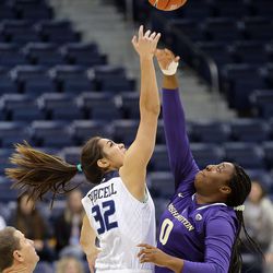 Brigham Young Cougars forward Kalani Purcell (32) and Washington Huskies forward/center Chantel Osahor (0) go up for the opening tipoff during NCAA basketball In Provo on Thursday, Dec. 22, 2016.