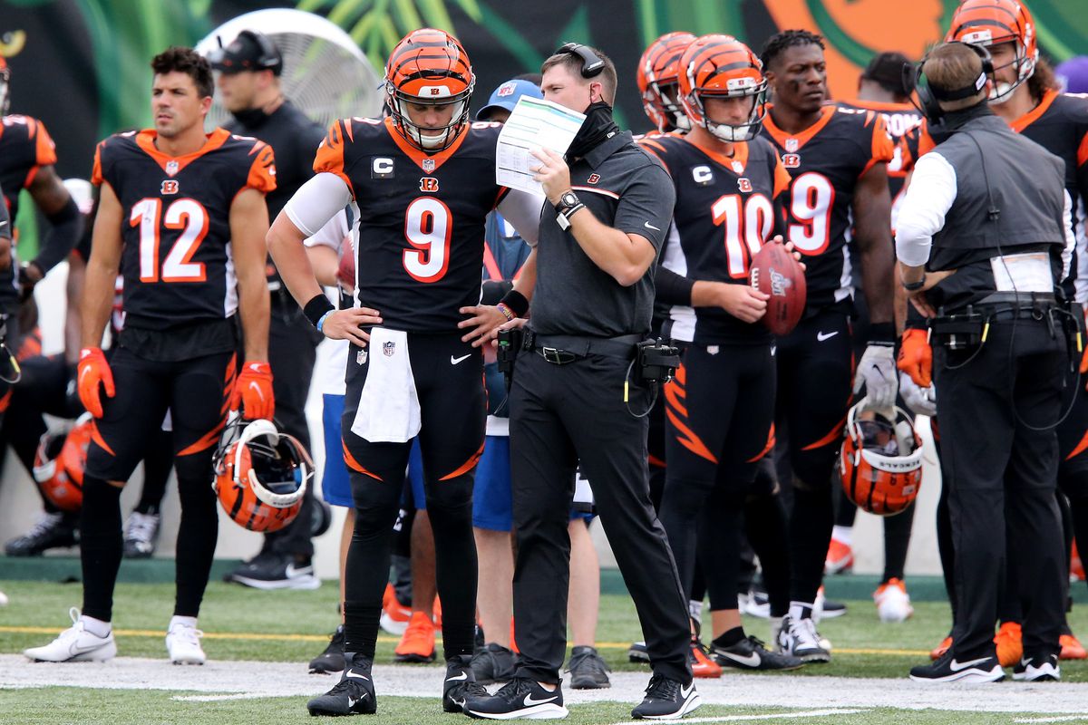 Cincinnati Bengals head coach Zac Taylor and Cincinnati Bengals quarterback Joe Burrow (9) talk during a timeout in the second quarter of a Week 1 NFL football game against the Los Angeles Chargers, Sunday, Sept. 13, 2020, at Paul Brown Stadium in Cincinnati.