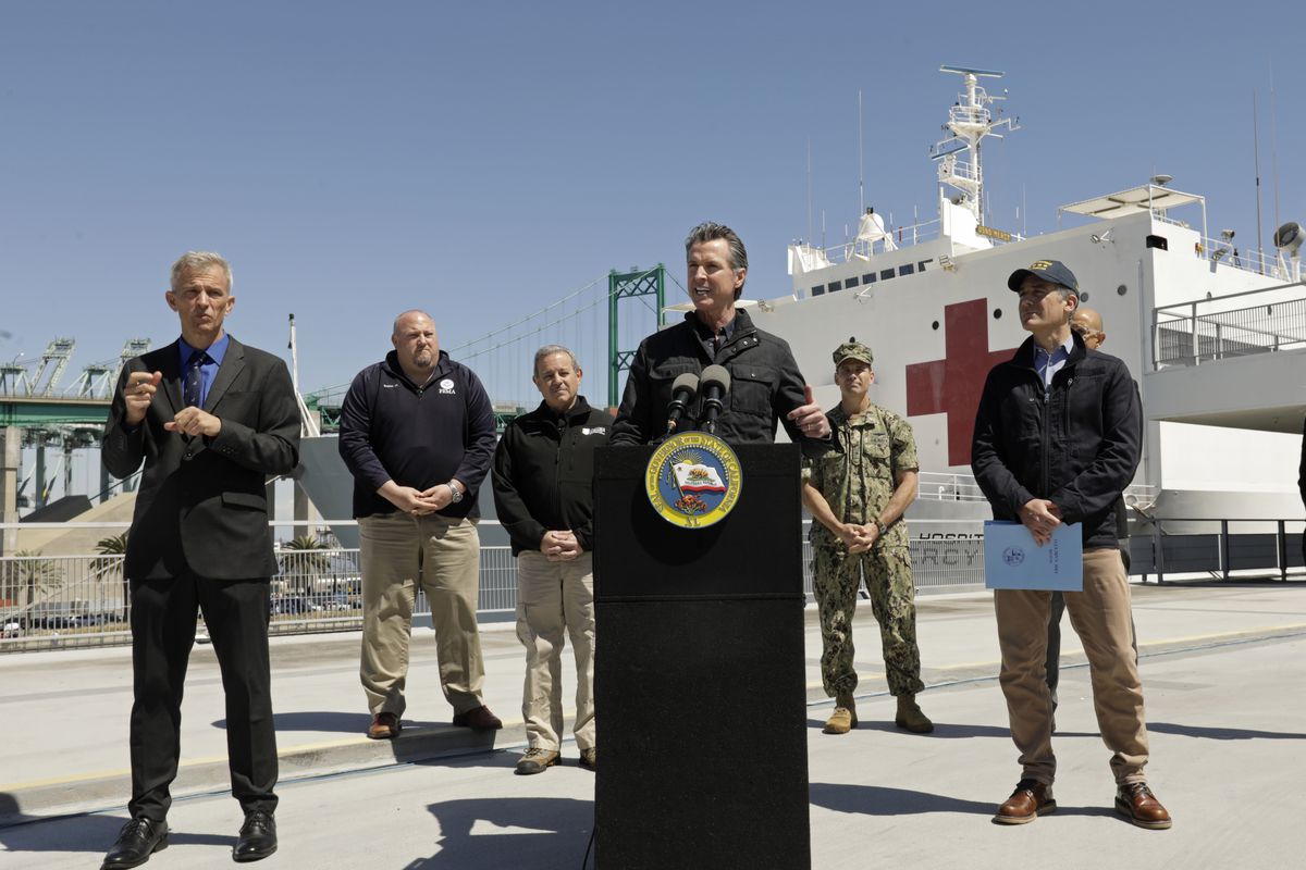 California Governor Gavin Newsom speaks in front of the hospital ship USNS Mercy that arrived into the Port of Los Angeles on Friday, March 27, 2020, to provide relief for Southland hospitals overwhelmed by the coronavirus pandemic.