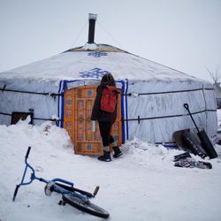 In this Thursday, Dec. 1, 2016 photo, a student walks into the school at the Oceti Sakowin camp where people have gathered to protest the Dakota Access pipeline near Cannon Ball, N.D. The school teaches on average 20 students a day in the traditional Lakota curriculum as well as math, reading and writing. 