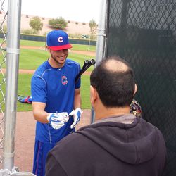 Kris Bryant signing autographs (there's a kid in front of the man in the sweatshirt)