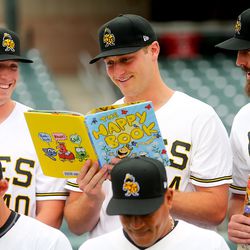 Bees' players Jeremy Rhoades, Matt Custred, Forrest Snow and the rest of the team look at books as part of their reading program as the Salt Lake Bees hold their media day at Smith's Ballpark on Tuesday, April 2, 2019.