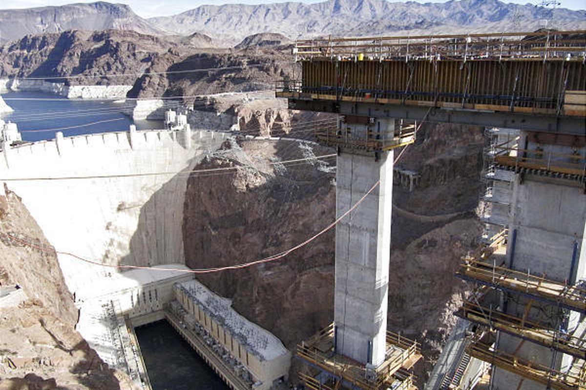 A towering column that will support a bridge replacing the roadway over the Hoover Dam is seen next to the dam.