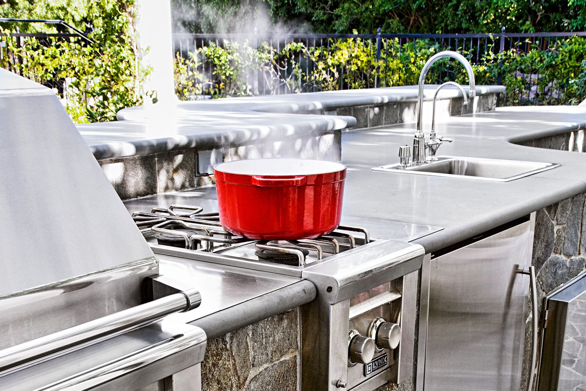 Stainless steel outdoor kitchen with sink and refrigerator