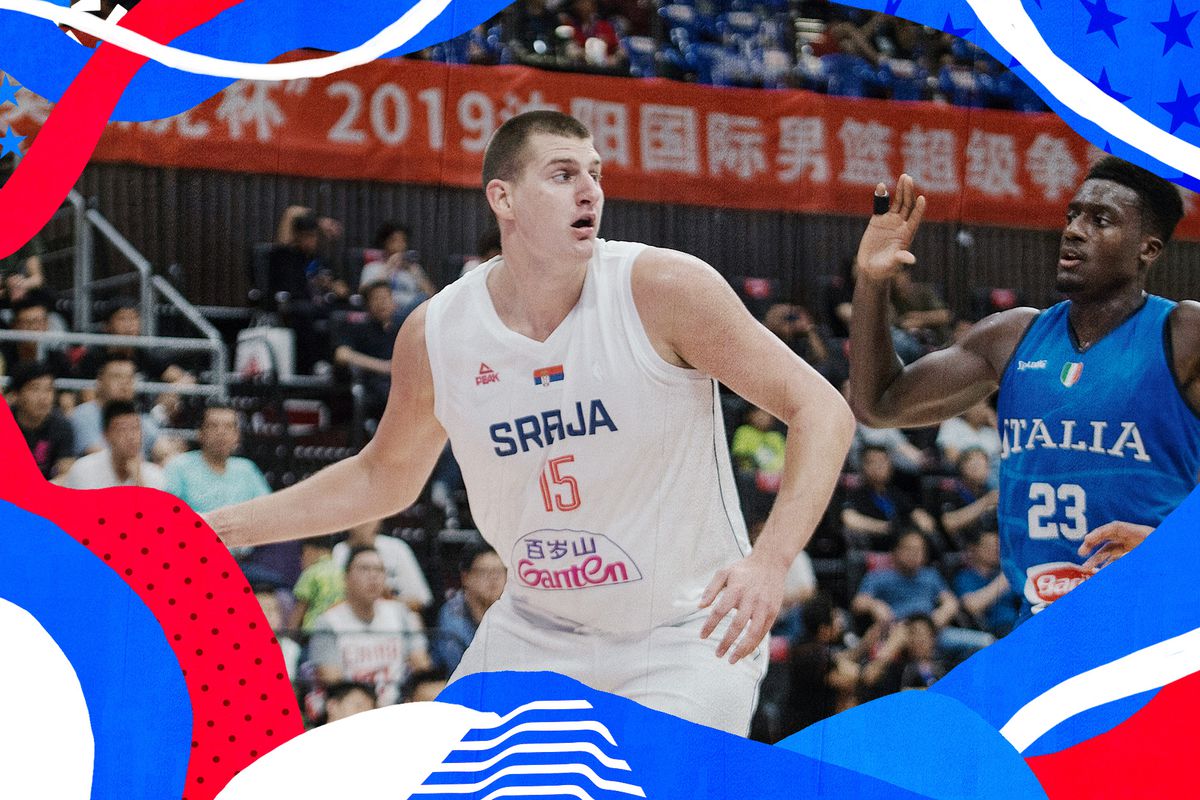 Serbia’s Nikola Jokic, controlling the ball with his right hand, attempts to make a move in front of Italy’s Awudu Abass.