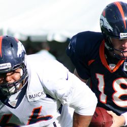 Broncos center Manny Ramirez continues to work at center with Peyton Manning
