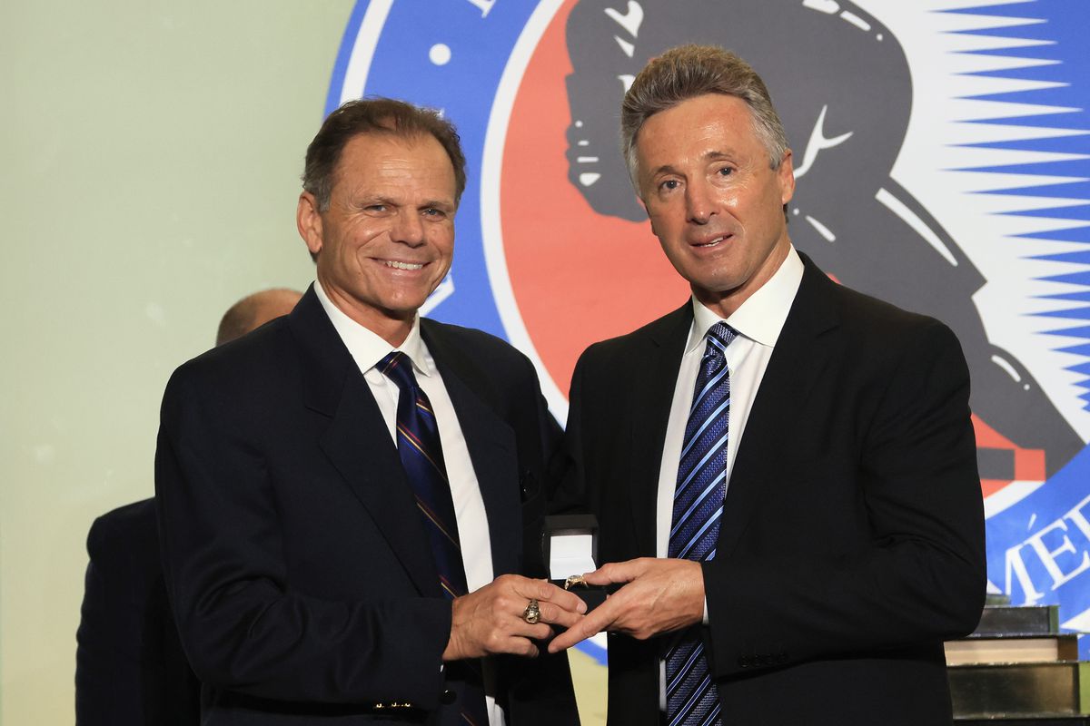 Member of the selection committee Mike Gartner (L) presents a Hall of Fame ring to Doug Wilson at the Hockey Hall Of Fame on November 12, 2021 in Toronto, Ontario, Canada.