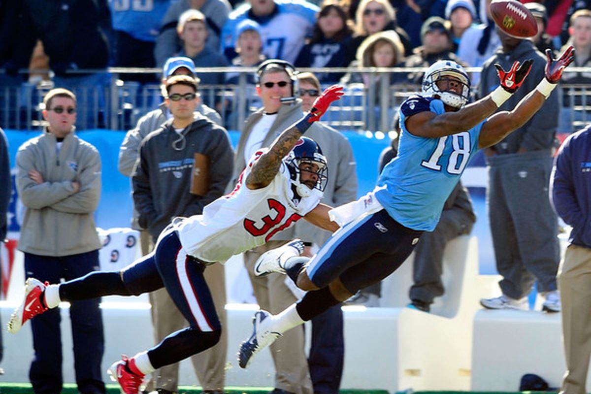NASHVILLE TN - DECEMBER 19:  Jason Allen #20 of the Houston Texans defends a pass to Kenny Britt #18 of the Tennessee Titans  during the first half at LP Field on December 19 2010 in Nashville Tennessee.  (Photo by Grant Halverson/Getty Images)