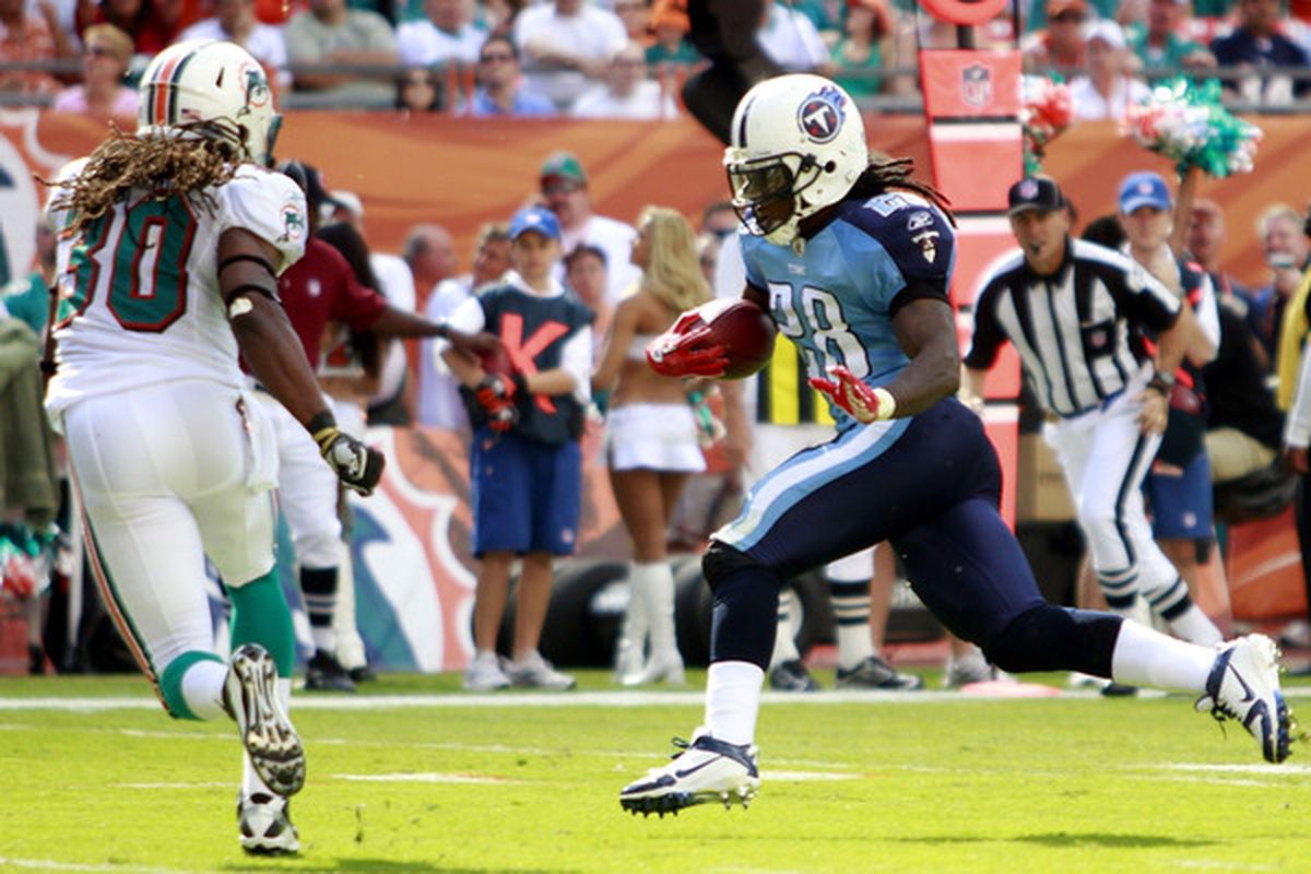 MIAMI - NOVEMBER 14:  Running back Chris Johnson #28 of the Tennessee Titans scores a touchdown  against Chris Clemons #30 of the Miami Dolphins at Sun Life Stadium on November 14 2010 in Miami Florida.  (Photo by Marc Serota/Getty Images)