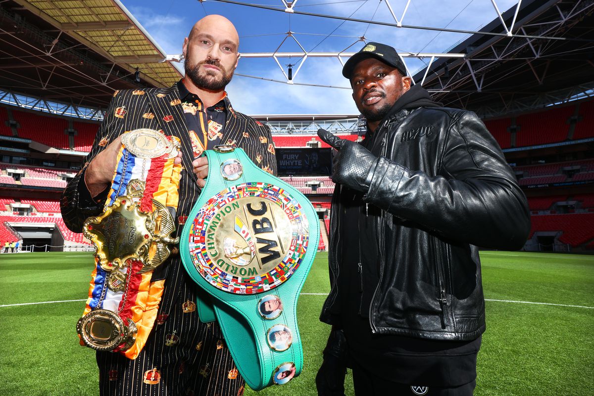 Tyson Fury (L) and Dillian Whyte (R) face-off during the press conference prior to their WBC heavyweight championship fight at Wembley Stadium on April 20, 2022 in London, England.