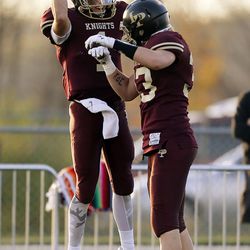 Dakota Hansen and David Smuin of Lone Peak celebrate a touchdown by Hansen against Jordan during 5A high school football action in Highland on Friday, Nov. 4, 2016.