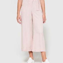 Pair wide leg pants in the style of a wrap skirt with heels and a loose-fitting blouse for  the work week, and sneakers and a bodysuit for the weekend.