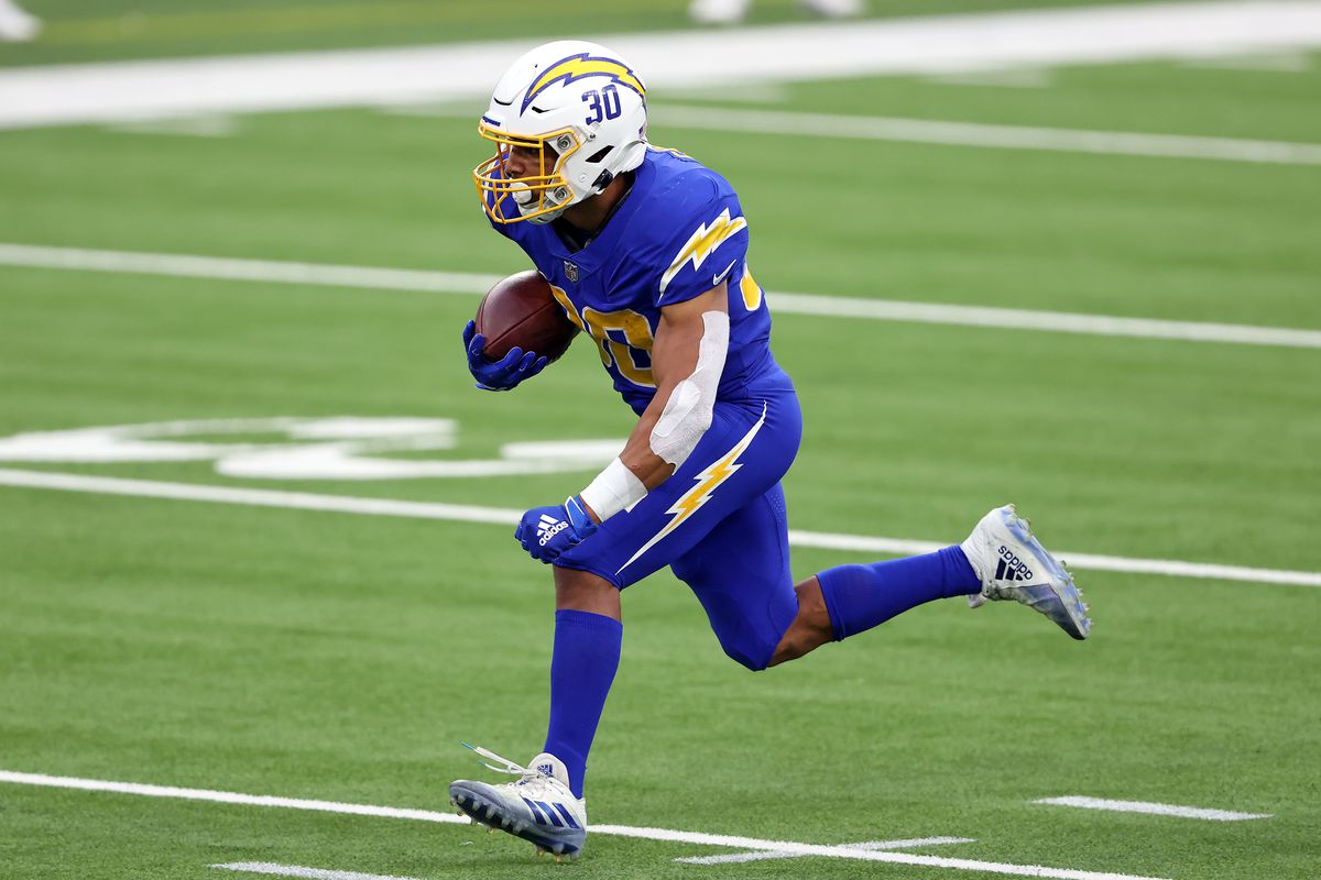 Austin Ekeler of the Los Angeles Chargers runs the ball against the Atlanta Falcons during the second quarter at SoFi Stadium on December 13, 2020 in Inglewood, California.