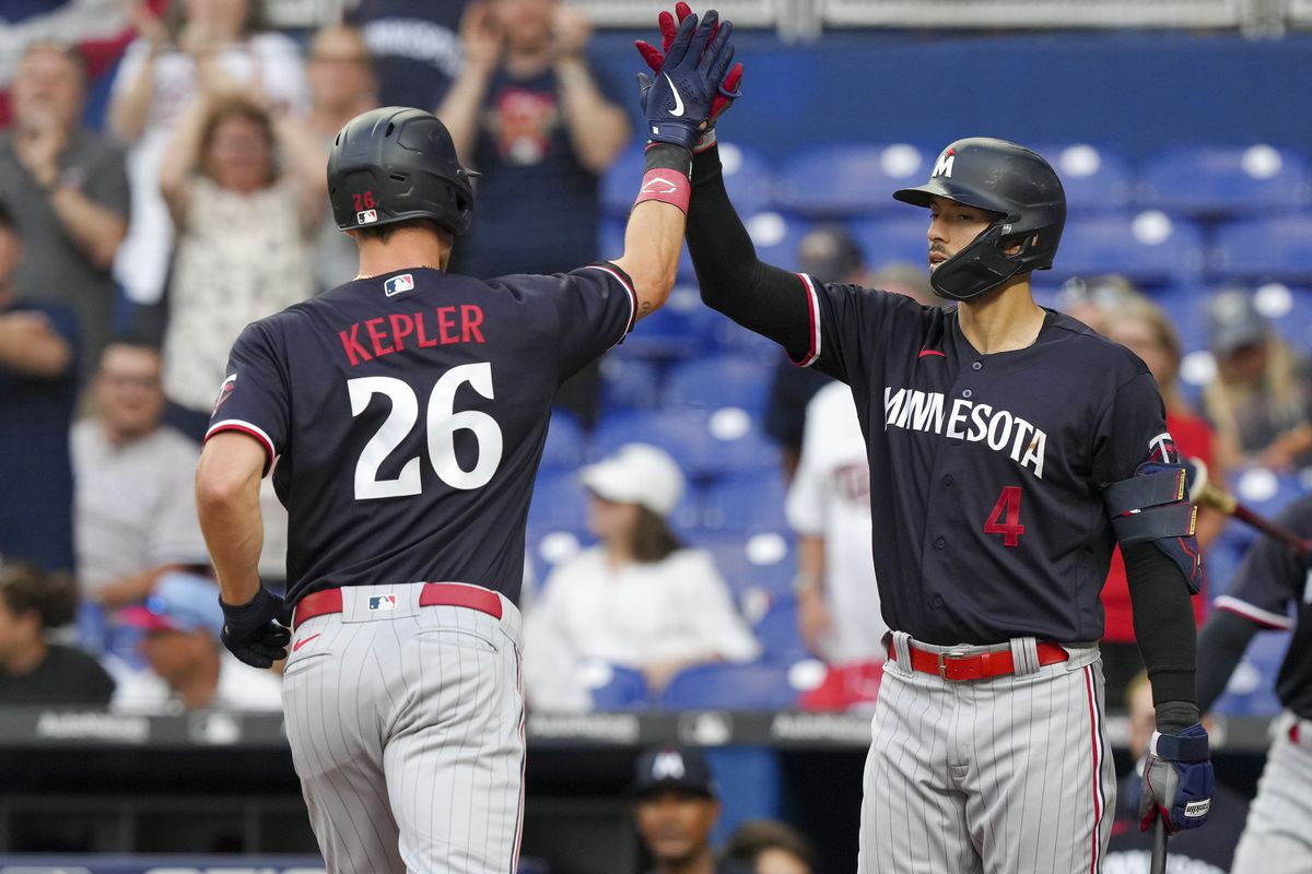 Max Kepler #26 of the Minnesota Twins is congratulated by Carlos Correa #4 after hitting a home run in the first inning against the Miami Marlins at loanDepot park on April 03, 2023 in Miami, Florida.