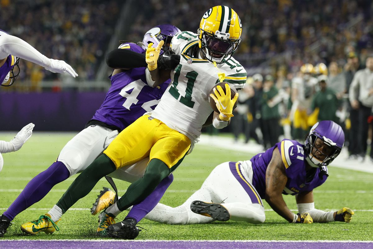 Jayden Reed #11 of the Green Bay Packers scores a touchdown during the second quarter against the Minnesota Vikings at U.S. Bank Stadium on December 31, 2023 in Minneapolis, Minnesota.