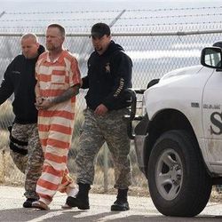 Sanpete Sheriff's Officers escort Troy James Knapp, 45, to the Sanpete County Jail Tuesday, April 2, 2013, in Manti, Utah. Authorities on Tuesday captured Knapp, an elusive survivalist who is suspected of burglarizing Utah cabins and leaving some covered with threats and bullet holes  ending a saga that began six years ago and drew in police and residents around the state. Knapp, dubbed the "Mountain Man" by cabin owners, was taken into custody in the snowy mountains outside of Ferron in central Utah after firing several shots at officers in a helicopter, authorities said. (AP Photo/Rick Bowmer)