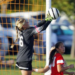 American Fork goalkeeper Savanna Empey (66) punches the ball away from goal against Davis during the 5A girls soccer playoffs in Kaysville, Thursday, Oct. 15, 2015.