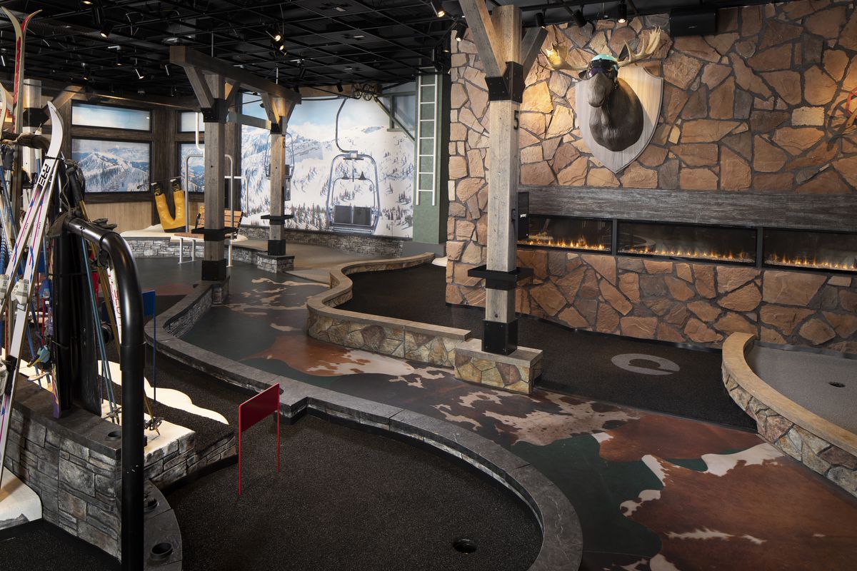 The Puttery’s skiing-inspired lodge-themed room offers a backdrop of the snow Rocky Mountains.