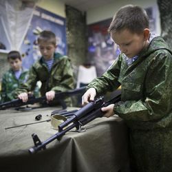 In this photo taken on Friday, Oct. 28, 2016, Alexander Yadryshnikov, 10, front, and his friends past apart Kalashnikov rifles as part of training in Verkhnyaya Pyshma, just outside Yekaterinburg, Russia. The training has been run by Yunarmia (Young Army), an organization sponsored by the Russian military that aims to encourage patriotism among the Russian youth. 