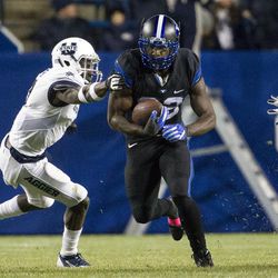 Brigham Young running back Squally Canada (22) carries the ball through a hole in the line during an NCAA college football game against Utah State in Provo on Saturday, Nov. 27, 2016. Brigham Young defeated in-state foe Utah State 28-10.
