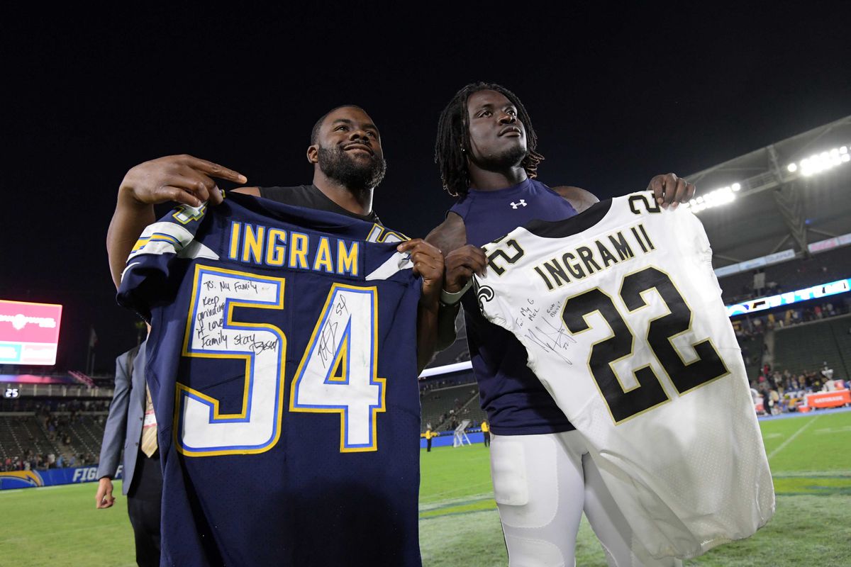 Carson, CA - New Orleans Saints running back Mark Ingram (left) and Los Angeles Chargers defensive end Melvin Ingram pose after exchanging jerseys after an NFL preseason football game at StubHub Center.