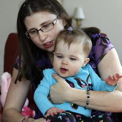 Masha Bean plays with her daughter, Julianna, in Holladay on Monday, Feb. 11, 2013. Julianna had surgery for a hole in her heart three months after she was born.