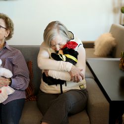 Betty Brewer, left, and Gladys Tucker hold teddy bears before presenting them to Salt Lake City police detective Robert Ungricht at The Ridge Foothill, a retirement community, in Salt Lake City on Wednesday, Jan. 30, 2019. Police officers often give the teddy bears to children who are coping with trauma following accidents.