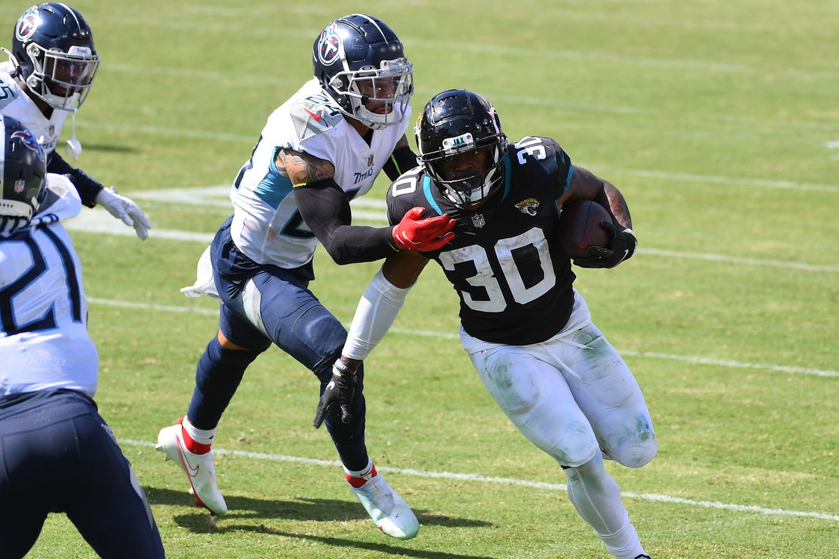 Jacksonville Jaguars running back James Robinson gets away from a tackle attempt by Tennessee Titans strong safety Kenny Vaccaro during the second half at Nissan Stadium