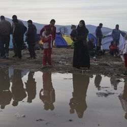 Migrants living in tents reflected in a puddle of water at the northern Greek border station of Idomeni, Tuesday, March 8, 2016. Up to 14,000 people are stranded on the outskirts of the village of Idomeni, with more than 36,000 in total across Greece, as EU leaders who held a summit with Turkey on Monday said they hoped they had reached the outlines of a possible deal with Ankara to return thousands of migrants to Turkey. 