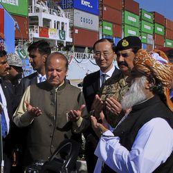 Pakistan's Prime Minister Nawaz Sharif, center left, and Army Chief General Raheel Sharif, fourth right, pray after inaugurating a new international trade route during a ceremony at Gwadar port, about 435 miles, 700 km, west of Karachi. Pakistan, Sunday, Nov. 13, 2016. Pakistan's top civil and military leaders opened the new route by seeing off a Chinese ship that's exporting goods to the Middle East and Africa from the newly built Gwadar port. Chinese Ambassador to Pakistan Sun Weidong, center, attended. 