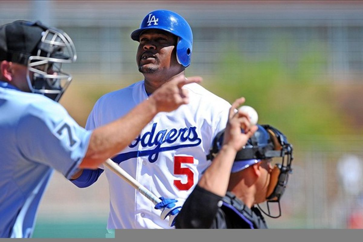 Mar 13, 2012; Glendale, AZ, USA; Los Angeles Dodgers third baseman Juan Uribe (5) watches a called strike during the third inning against the Colorado Rockies at Camelback Ranch. Mandatory Credit: Christopher Hanewinckel-US PRESSWIRE
