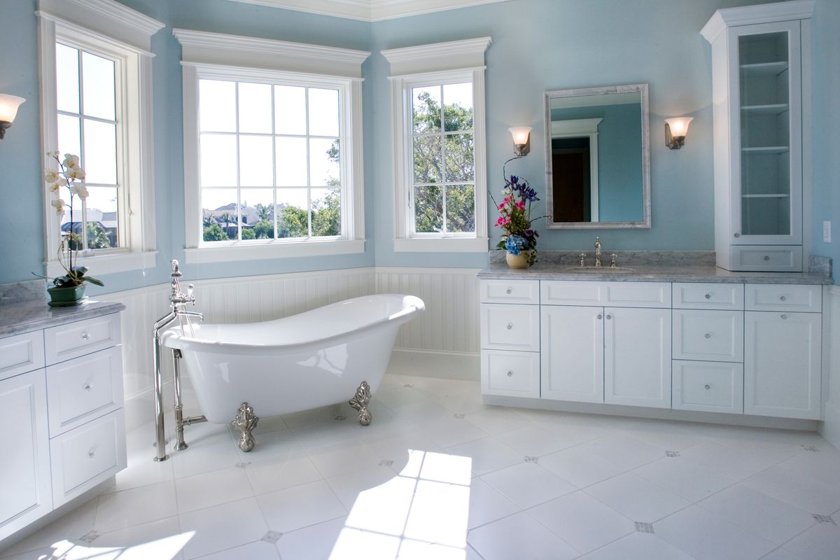 Powder blue bathroom with a free standing tub.