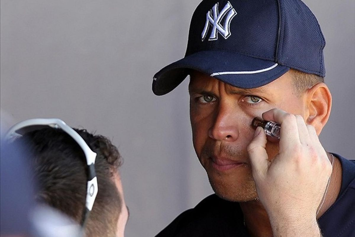 March 2, 2012; Tampa, FL, USA; New York Yankees third baseman Alex Rodriguez (13) has eye black applied before the game against the South Florida Bulls during spring training at George M. Steinbrenner Field. Mandatory Credit: Kim Klement-US PRESSWIRE