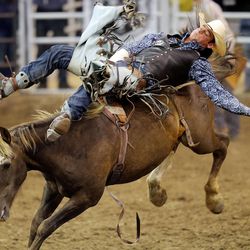Kyle Brennecke competes in the bareback ride during the Days of 47 Rodeo Tuesday, July 22, 2014, at EnergySolutions Arena in Salt Lake City.