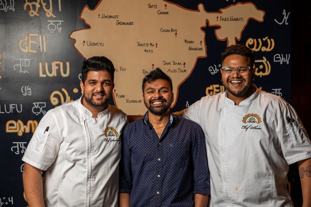 Sachin Darade, Aman Kota, and Sarthak Samantray&nbsp;of LUFU NOLA in front of a hand-painted regional map of India.