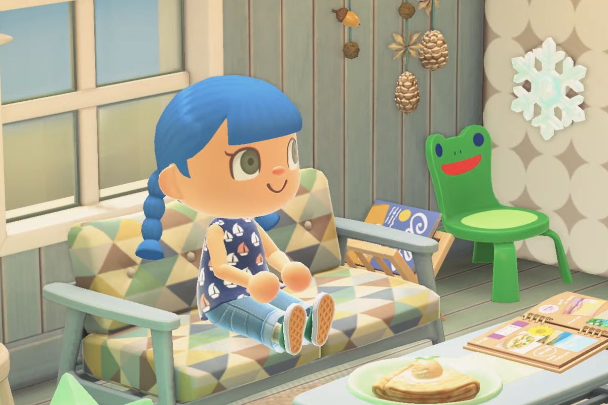 a character with blue hair sitting next to a froggy chair
