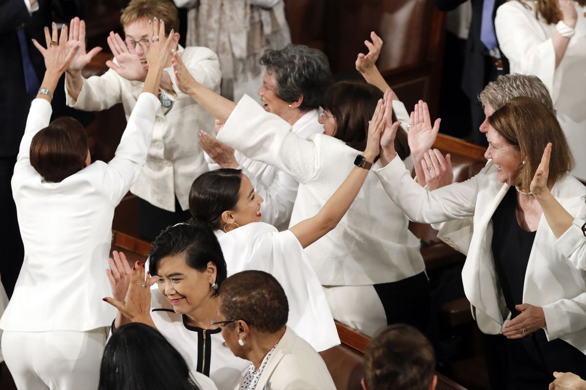 Women members of Congress, including Rep. Alexandria Ocasio-Cortez, D-N.Y., center, cheer after President Donald Trump acknowledges more women in Congress during his State of the Union address to a joint session of Congress on Capitol Hill in Washington, 