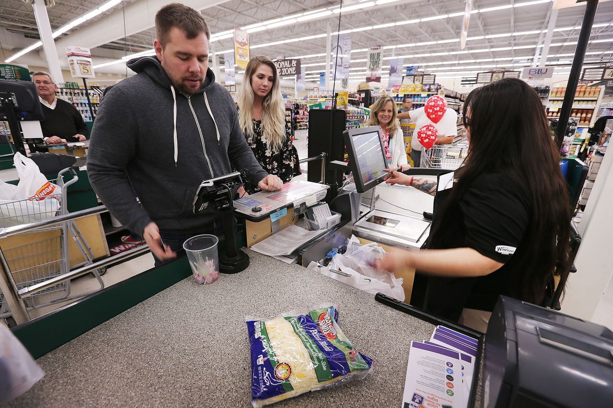 Craig Fox and Erin Houlberg are helped by checker Crystal Rodriguez at Winegars in Bountiful on Tuesday, Feb. 14, 2017. Senate leaders said Tuesday that restoring the full state sales tax on food purchases remains an option this session to counter a proposed education funding initiative, even though tax exemptions will likely be studied over the interim.