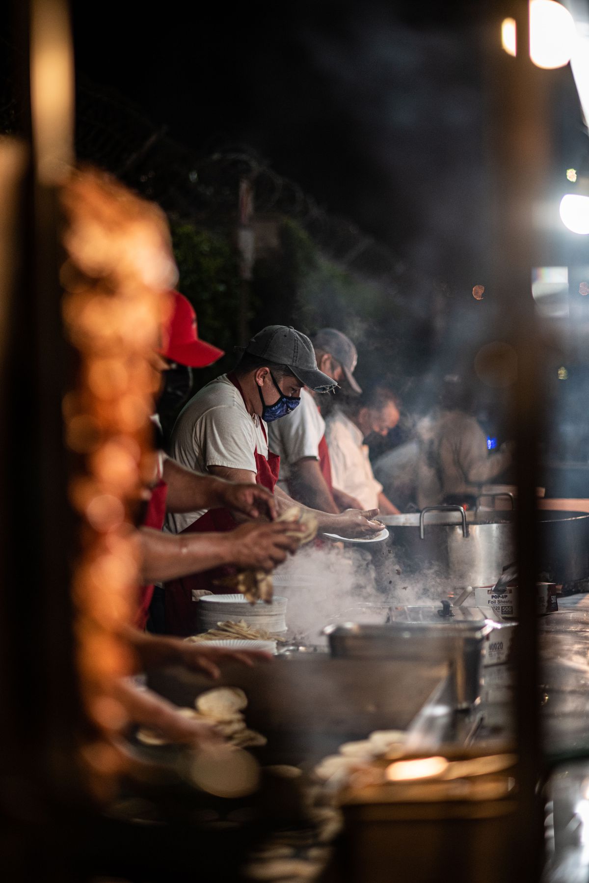 Taco street vendors preparing more tortillas.